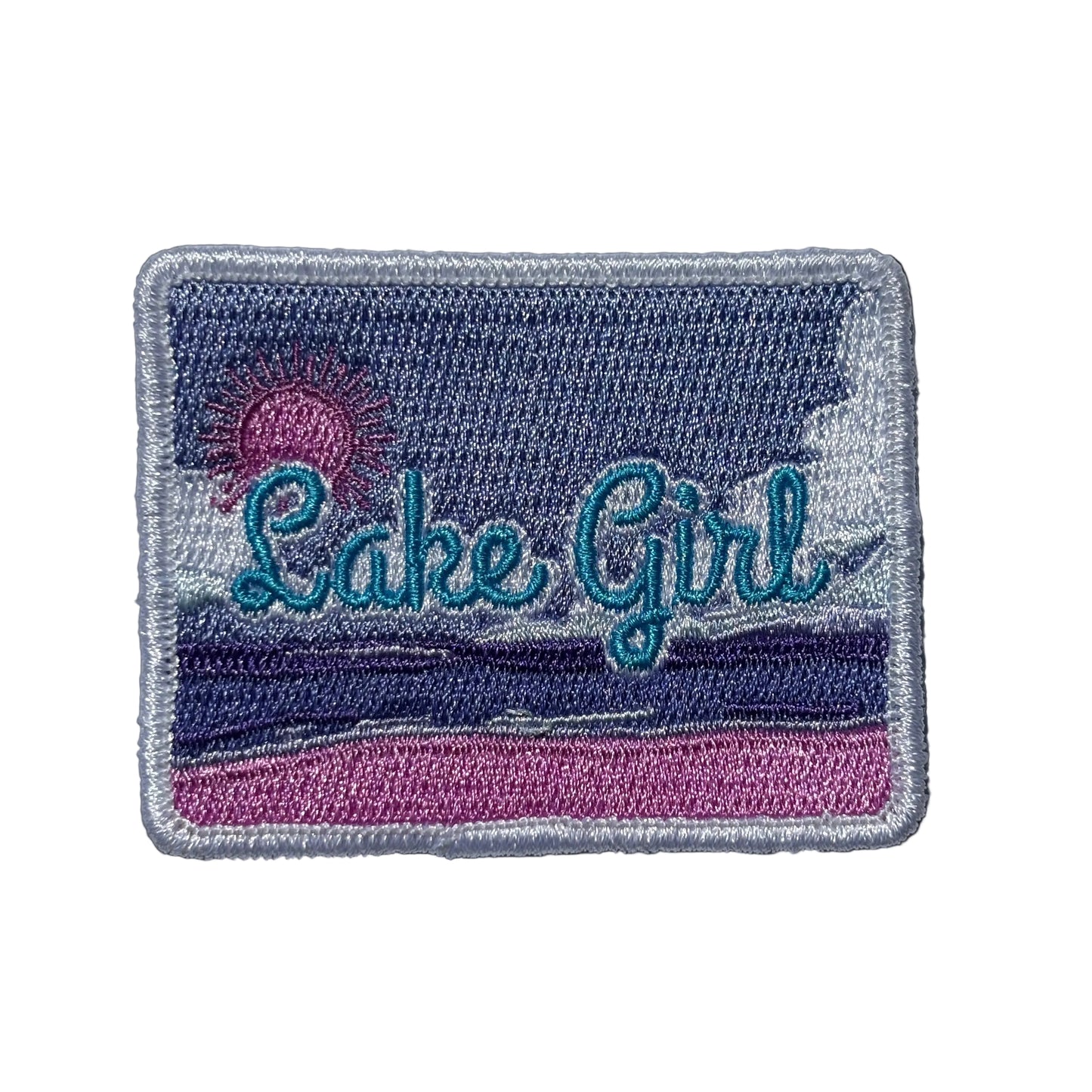 Embroidered patch with 'Lake Girl' text on a purple and pink beach background