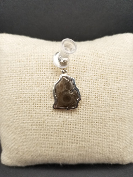 Mini Petoskey stone charm shaped into the lower peninsula mitt of michigan and embedded in a thick and sturdy sterling silver setting. Charm is thumb-tacked on to a small canvas jewelry pillow.