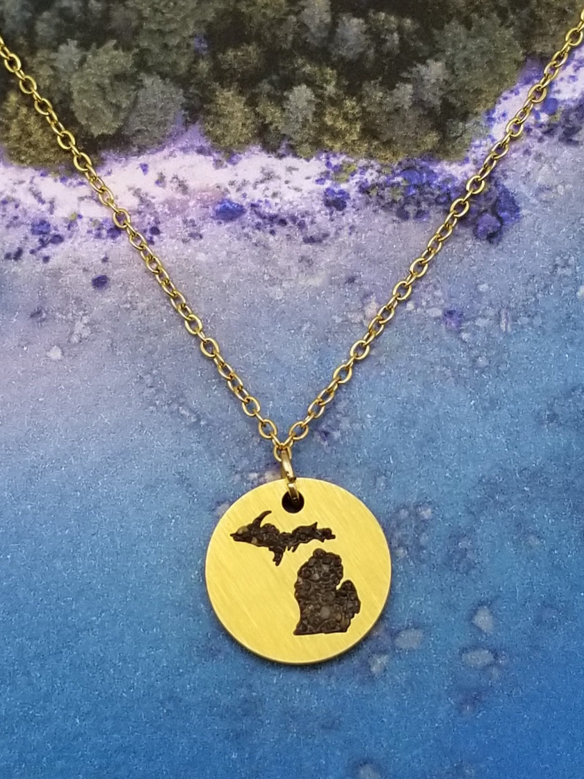 Round, gold, pendant necklace with inlay of the state of Michigan filled with sand from all five of the Great Lakes. Perfect souvenir for all ages.