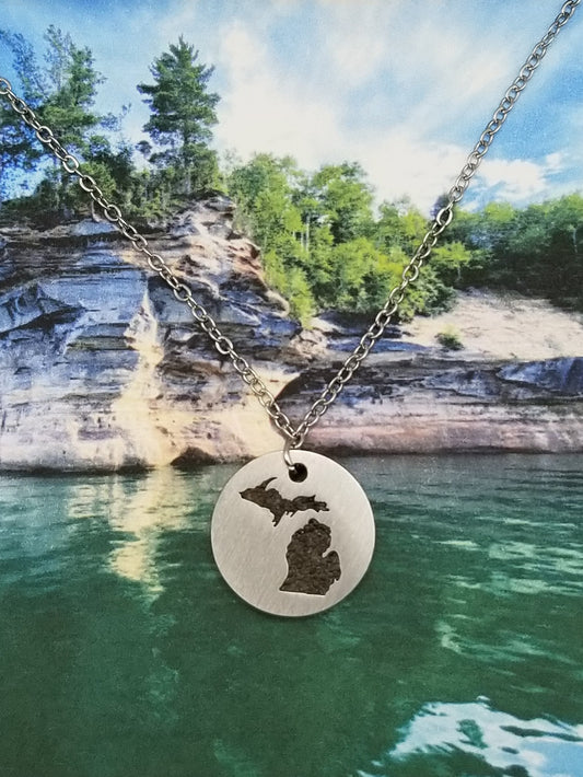Round, silver, pendant necklace with inlay of the state of Michigan filled with sand from all five of the Great Lakes. Perfect souvenir for all ages.
