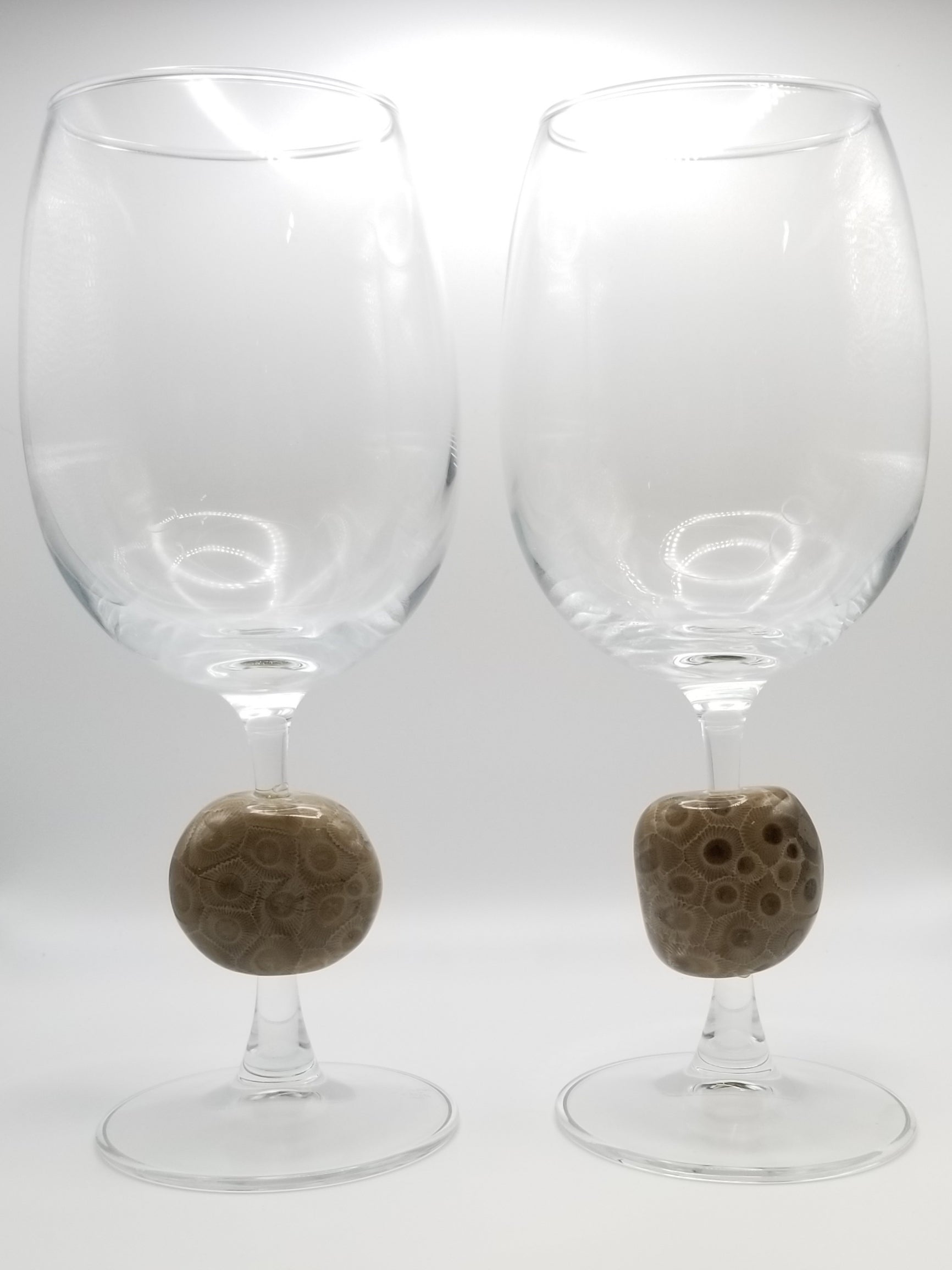 Two wine glasses with polished petoskey stones in the stem